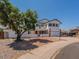 White two-story home boasts a well-manicured yard and an attached two-car garage at 13438 N 18Th Ln, Phoenix, AZ 85029