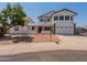 Inviting two-story home featuring a balcony, brick accents, and attached two-car garage at 13438 N 18Th Ln, Phoenix, AZ 85029