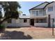 Two-story home with red brick pathway, balcony, and a low decorative front yard wall at 13438 N 18Th Ln, Phoenix, AZ 85029