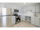 Well-lit kitchen featuring stainless steel appliances, gray cabinets and drawers, with a tiled backsplash at 13438 N 18Th Ln, Phoenix, AZ 85029