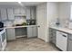 Grey kitchen featuring modern appliances, ample counter space, and stylish backsplash at 13438 N 18Th Ln, Phoenix, AZ 85029