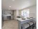 Beautiful kitchen featuring gray cabinetry, a breakfast bar, stainless appliances, and tiled backsplash at 13438 N 18Th Ln, Phoenix, AZ 85029