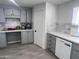 Bright kitchen with grey cabinets, white countertops, and a tile backsplash at 13438 N 18Th Ln, Phoenix, AZ 85029