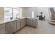 Bright kitchen with stainless steel dishwasher and sink, gray cabinets, and adjacent dining area at 13438 N 18Th Ln, Phoenix, AZ 85029