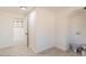 Bright laundry room with white walls, open shelving, tile floor, and washer/dryer hookups at 13438 N 18Th Ln, Phoenix, AZ 85029