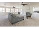 Bright living room featuring a fireplace, large windows, and stylish gray furniture at 13438 N 18Th Ln, Phoenix, AZ 85029
