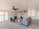 Spacious living room with carpeted floor, modern furniture, a cozy fireplace and french doors at 13438 N 18Th Ln, Phoenix, AZ 85029