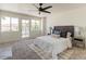 Calm main bedroom with plush bedding, and french doors that leads to an outdoor balcony at 13438 N 18Th Ln, Phoenix, AZ 85029