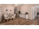 Open dining area with a glass table, four chairs, and wood-look flooring at 13644 W Aleppo Dr, Sun City West, AZ 85375
