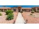 Charming single-story home featuring a beautifully landscaped front yard with a concrete walkway and desert landscaping at 13644 W Aleppo Dr, Sun City West, AZ 85375