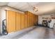 Spacious garage with custom built-in storage along the wall at 13644 W Aleppo Dr, Sun City West, AZ 85375