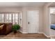 Bright living room featuring wood floors, plantation shutters, and a neutral color palette at 13644 W Aleppo Dr, Sun City West, AZ 85375