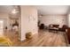 Bright and open living room showcasing wood floors, a neutral color scheme, and seamless flow to the kitchen at 13644 W Aleppo Dr, Sun City West, AZ 85375