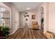 Open-concept living area boasts wood floors, neutral colors, and an abundance of natural light from plantation shutters at 13644 W Aleppo Dr, Sun City West, AZ 85375