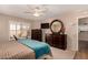 Bright bedroom featuring plantation shutters, ceiling fan, and ensuite bathroom access at 13644 W Aleppo Dr, Sun City West, AZ 85375