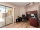 Cozy home office featuring wood floors, lots of natural light, and a desk with shelving at 13644 W Aleppo Dr, Sun City West, AZ 85375