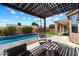 Beautiful backyard patio with pergola, hanging chair and an inviting pool at 15020 N 54Th Pl, Scottsdale, AZ 85254