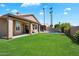 Beautiful backyard featuring lush green lawn, inviting pool and covered patio at 15020 N 54Th Pl, Scottsdale, AZ 85254