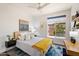 This bedroom includes a plush bed, modern art and a large window bringing in plenty of natural light at 15020 N 54Th Pl, Scottsdale, AZ 85254