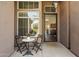 Cozy front porch area with a small table and chairs, creating a welcoming entry to the home at 15020 N 54Th Pl, Scottsdale, AZ 85254
