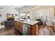 Beautiful kitchen island with stainless steel appliances, hardwood floors, and seamless flow to living space at 15020 N 54Th Pl, Scottsdale, AZ 85254