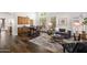 Inviting living room featuring hardwood floors, neutral decor, and seamless flow to dining area at 15020 N 54Th Pl, Scottsdale, AZ 85254