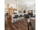 Open-concept kitchen and living area with stainless steel appliances, hardwood floors, and a breakfast bar at 15020 N 54Th Pl, Scottsdale, AZ 85254