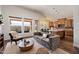 Elegant living room with seamless flow to the kitchen, hardwood floors, and ample natural light at 15020 N 54Th Pl, Scottsdale, AZ 85254