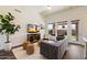 Modern living room with hardwood floors, stylish furnishings, and ample natural light from large windows at 15020 N 54Th Pl, Scottsdale, AZ 85254