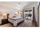 Serene bedroom with hardwood floors, natural light, and sliding glass doors leading to a private backyard at 15020 N 54Th Pl, Scottsdale, AZ 85254