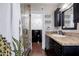 The bathroom features a shower with decorative tile and a vanity with granite countertop at 1551 E Glencove St, Mesa, AZ 85203