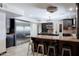 Elegant kitchen boasts custom dark cabinets, granite countertops, and stainless steel appliances at 1551 E Glencove St, Mesa, AZ 85203