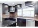 Well-appointed kitchen features dark cabinetry, granite countertops, and stainless steel appliances at 1551 E Glencove St, Mesa, AZ 85203