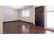 Bright living room showcasing wood-look tile floors and a large window for natural light at 1551 E Glencove St, Mesa, AZ 85203