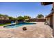 The spacious backyard features a pool, stamped concrete, rock accents, and desert landscaping at 1551 E Glencove St, Mesa, AZ 85203