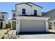 Two-story home with two car garage, desert landscaping, gray brick driveway, and light green front door at 1552 N Pueblo Dr, Apache Junction, AZ 85120
