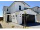 Charming two-story home with a black garage door, neutral color scheme, and well-manicured desert landscaping at 1576 N Pueblo Dr, Apache Junction, AZ 85120