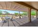 Comfortable backyard patio with pergola, outdoor seating, and a serene desert landscape view at 16287 W Willow Creek Ln, Surprise, AZ 85374