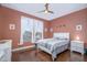Bedroom with a white bed frame, white dresser, and hardwood floors providing a comfortable space at 16287 W Willow Creek Ln, Surprise, AZ 85374