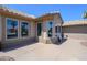 Exterior view featuring well-maintained patio, neutral stucco, and manicured desert landscaping at 16287 W Willow Creek Ln, Surprise, AZ 85374