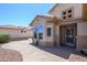 Stylish front entrance with elegant architectural details, a security door, and desert landscaping at 16287 W Willow Creek Ln, Surprise, AZ 85374