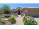 Charming home featuring well-manicured front yard, desert landscaping, and a cozy entryway at 16287 W Willow Creek Ln, Surprise, AZ 85374