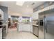 Bright kitchen features stainless steel appliances, granite countertops, and an open layout to the dining area at 16287 W Willow Creek Ln, Surprise, AZ 85374