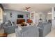 Comfortable living room with neutral walls, plush seating, and a large television at 16287 W Willow Creek Ln, Surprise, AZ 85374