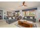 Bright living room featuring plush seating, a dining area, and large windows showcasing the outdoors at 16287 W Willow Creek Ln, Surprise, AZ 85374