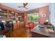 Office with a built in book shelf and wooden floors offering function and style at 16287 W Willow Creek Ln, Surprise, AZ 85374