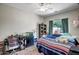 This cozy bedroom offers natural light, a ceiling fan, and direct access to the backyard at 17766 W Caribbean Ln, Surprise, AZ 85388