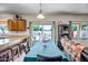 Open dining area with a long table, views of the pool, and a seamless transition to the kitchen at 17766 W Caribbean Ln, Surprise, AZ 85388