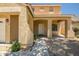 Charming covered front entrance with decorative columns, desert landscaping, and a well-lit walkway at 17766 W Caribbean Ln, Surprise, AZ 85388