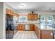 Well-equipped kitchen featuring wood cabinets, granite countertops, and stainless steel appliances at 17766 W Caribbean Ln, Surprise, AZ 85388